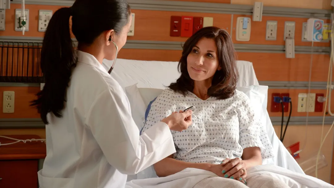 female patient in hospital bed