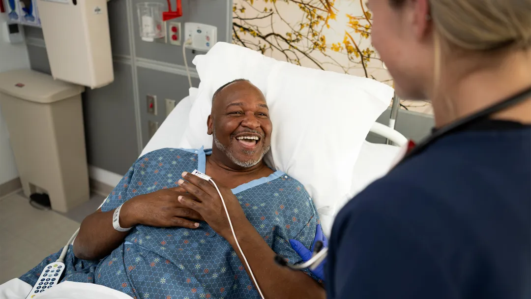 Nurse talking to patient and smiling 