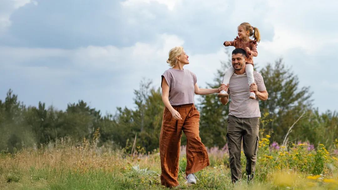 Family walking together in a meadow