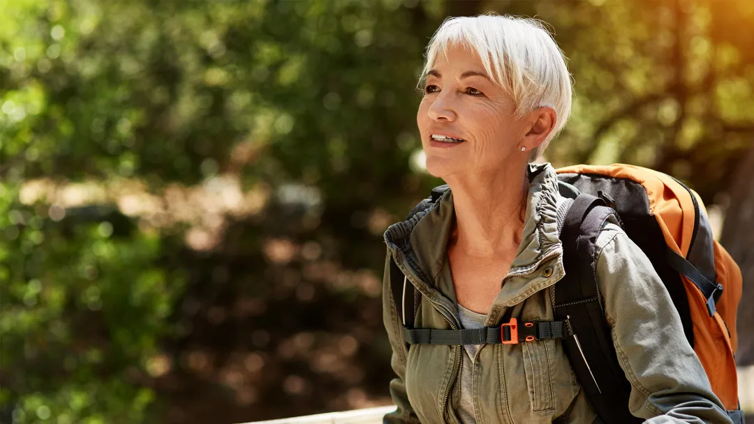 Older female backpacker out for a hike
