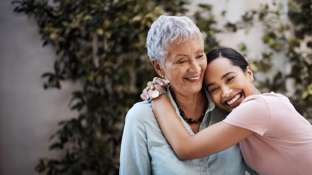 M teenage girl hugs her grandmother