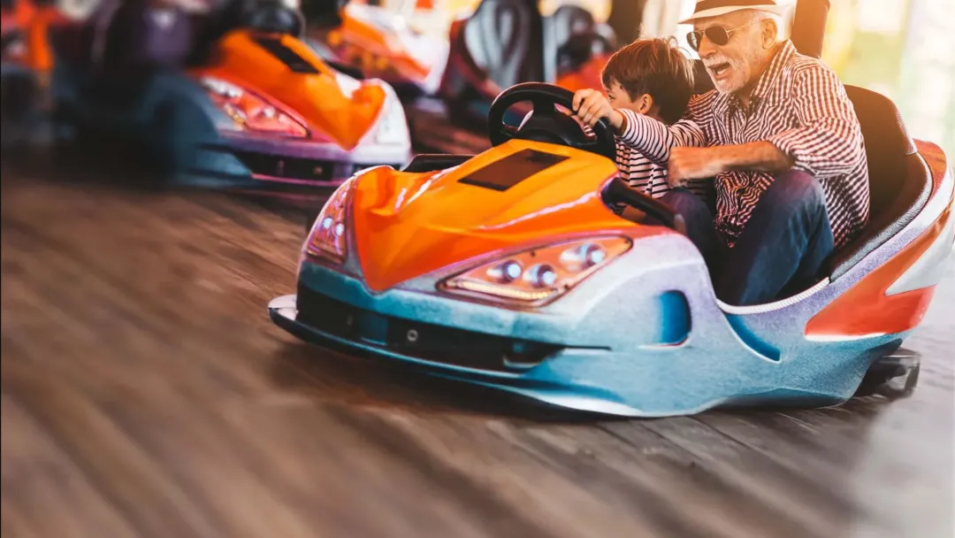 Grandfather and grandson in bumper car