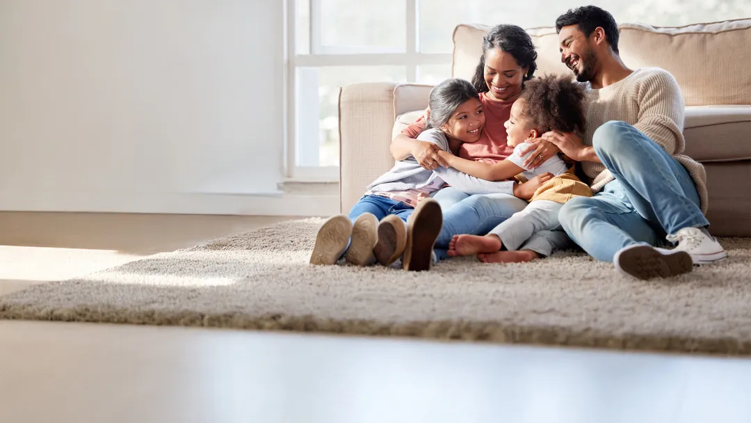 a family sitting on a rug