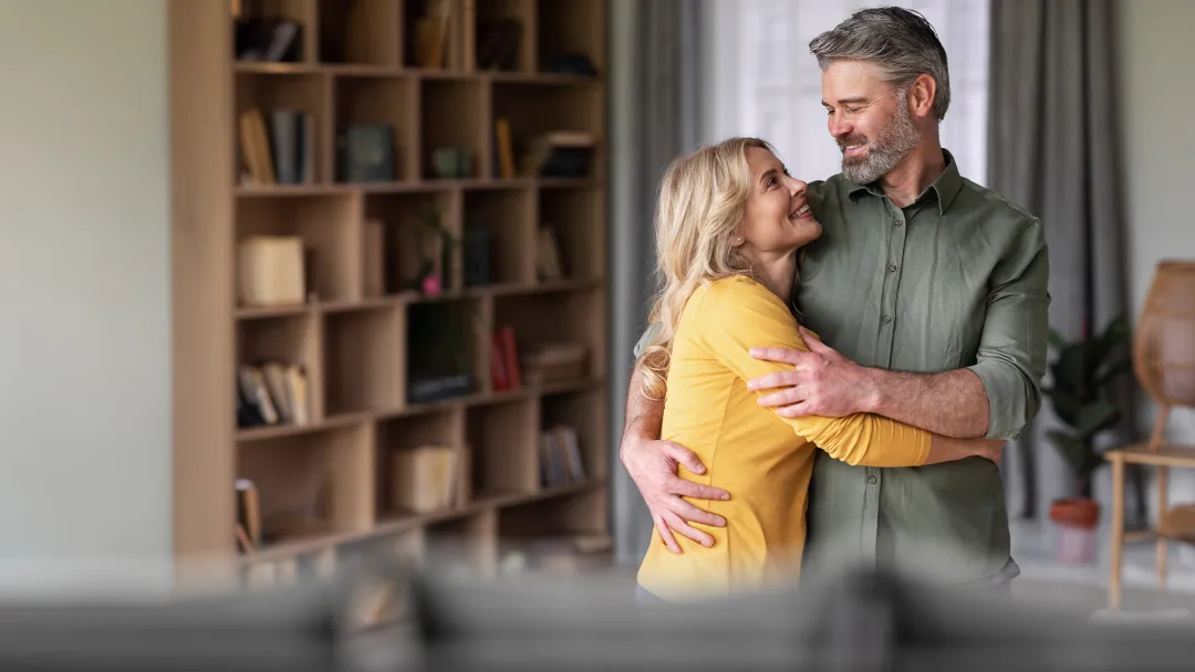 Man and woman hugging at home
