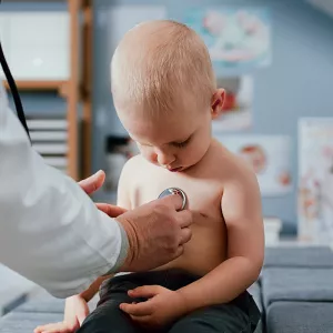AdventHealth physician checks young boy’s heart with stethoscope