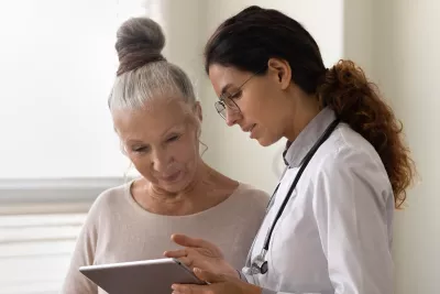 Doctor explaining to an older woman patient her test results.