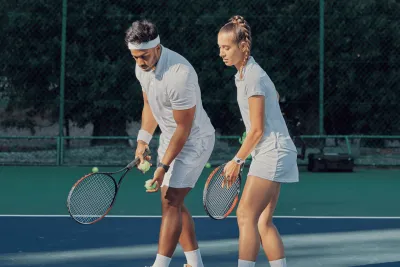 A man and woman playing tennis.