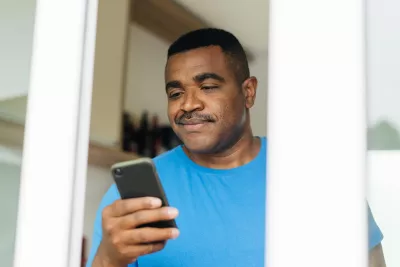 Man reading iPhone 