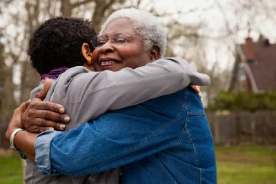 Woman Hugging Family Member