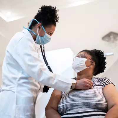 Female patient with female doctor with PPE