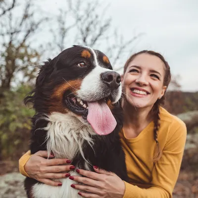 Woman Hugging Dog Smiling