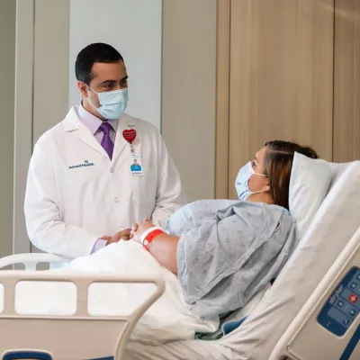 A Doctor Speaks to a Patient From Her Hospital Room.