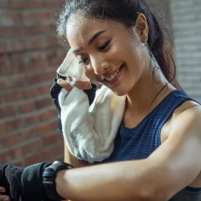 A runner takes a break to check her heart rate.