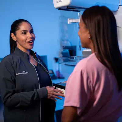 Physician speaking to patient near an imaging machine