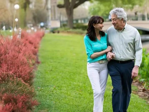 a mature couple walking outdoors