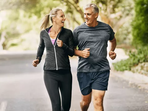 A man and a woman running on an incline