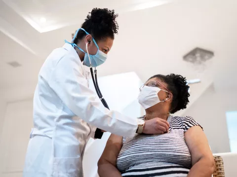 Female patient with female doctor with PPE