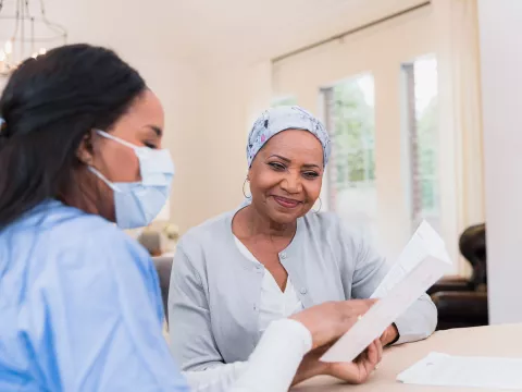 A Health Provider Covers Some Text with a Patient