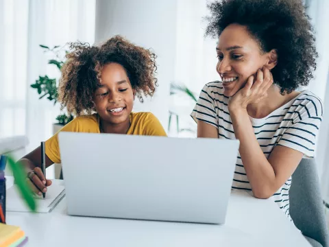 A Mother and Daughter Surf the Internet on a Laptop in Their Home.