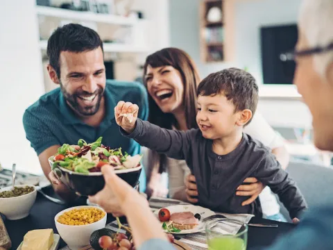 A Family Gathers Around The Kitchen Table To Enjoy Some Healthy Foods.