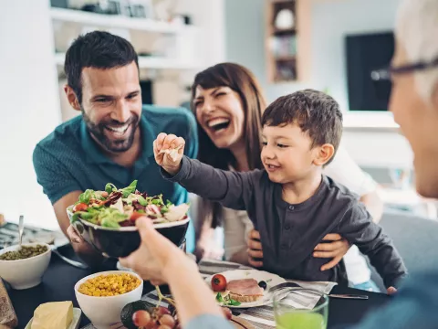  A Family Gathers Around The Kitchen Table To Enjoy Some Healthy Foods.