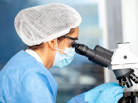 A histopathologist using a microscope