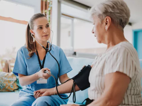 A Nurse Takes a Patient's Blood Pressure