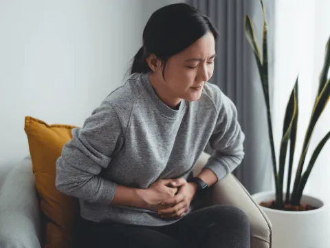 Woman grabbing her stomach
