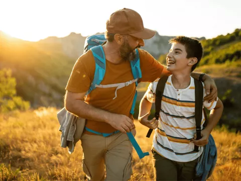 Dad and son hiking together.