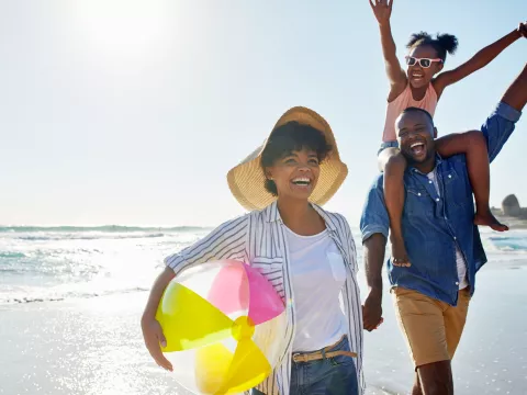 A healthy family enjoys a summer day on the beach.