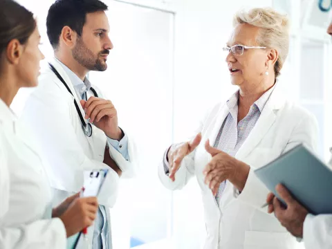 Physician's speaking with residents.