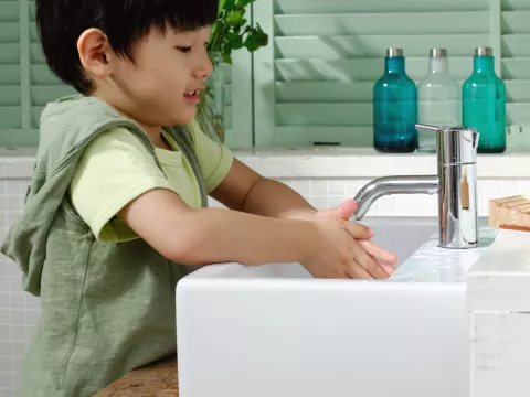 Little boy washing his hands