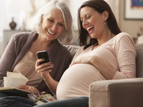 Pregnant woman looking at photos