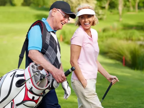 A couple enjoys a golf game together.