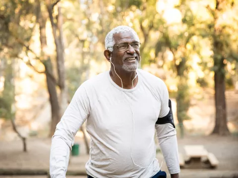 Older man excising outside