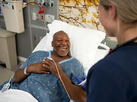 Nurse talking to patient and smiling 