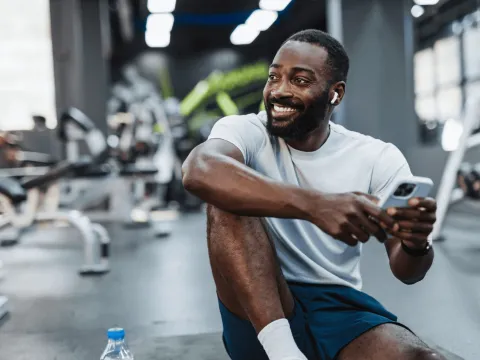 A man takes a rest during a workout at the gym.