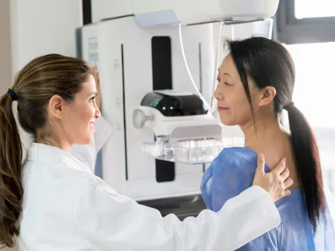 A woman about to receive a mammogram.