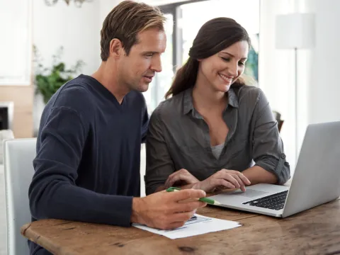 A couple making a list together at home.