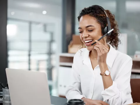 Female Professional using a laptop and headset