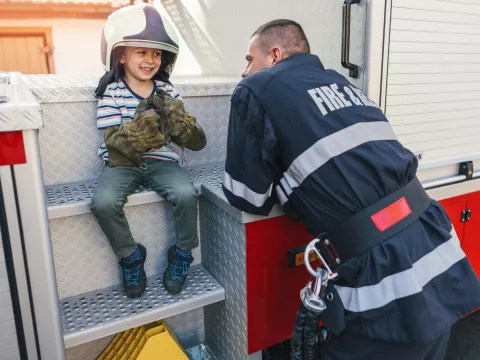 Smiling child with firefighter