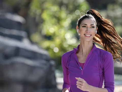 A Young Woman Runs Through the Park.