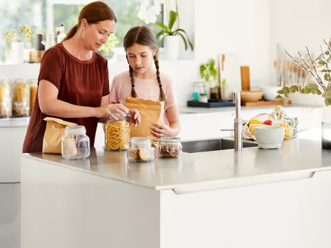 Mother and daughter preparing food.