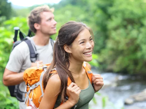 A happy couple hiking.