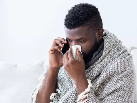 A man calling his doctor about his symptoms.