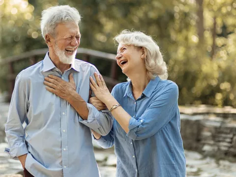 A mature couple walking outdoors.