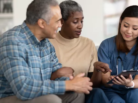 An older couple reviews their test results with their doctor.