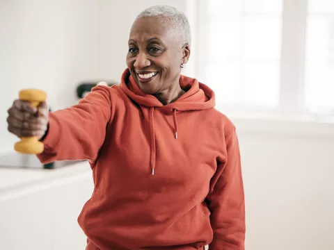 A mature woman exercising at home.