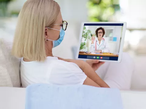 A woman visiting with a virtual doctor.