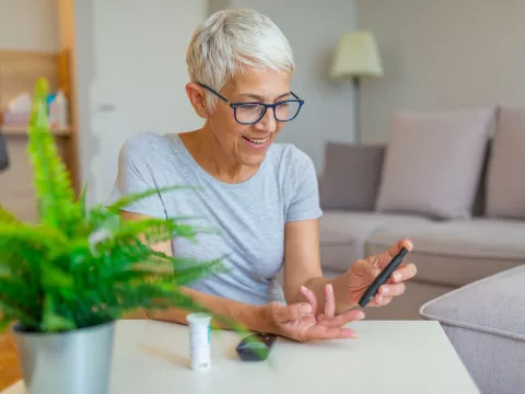 Woman checking blood sugar.